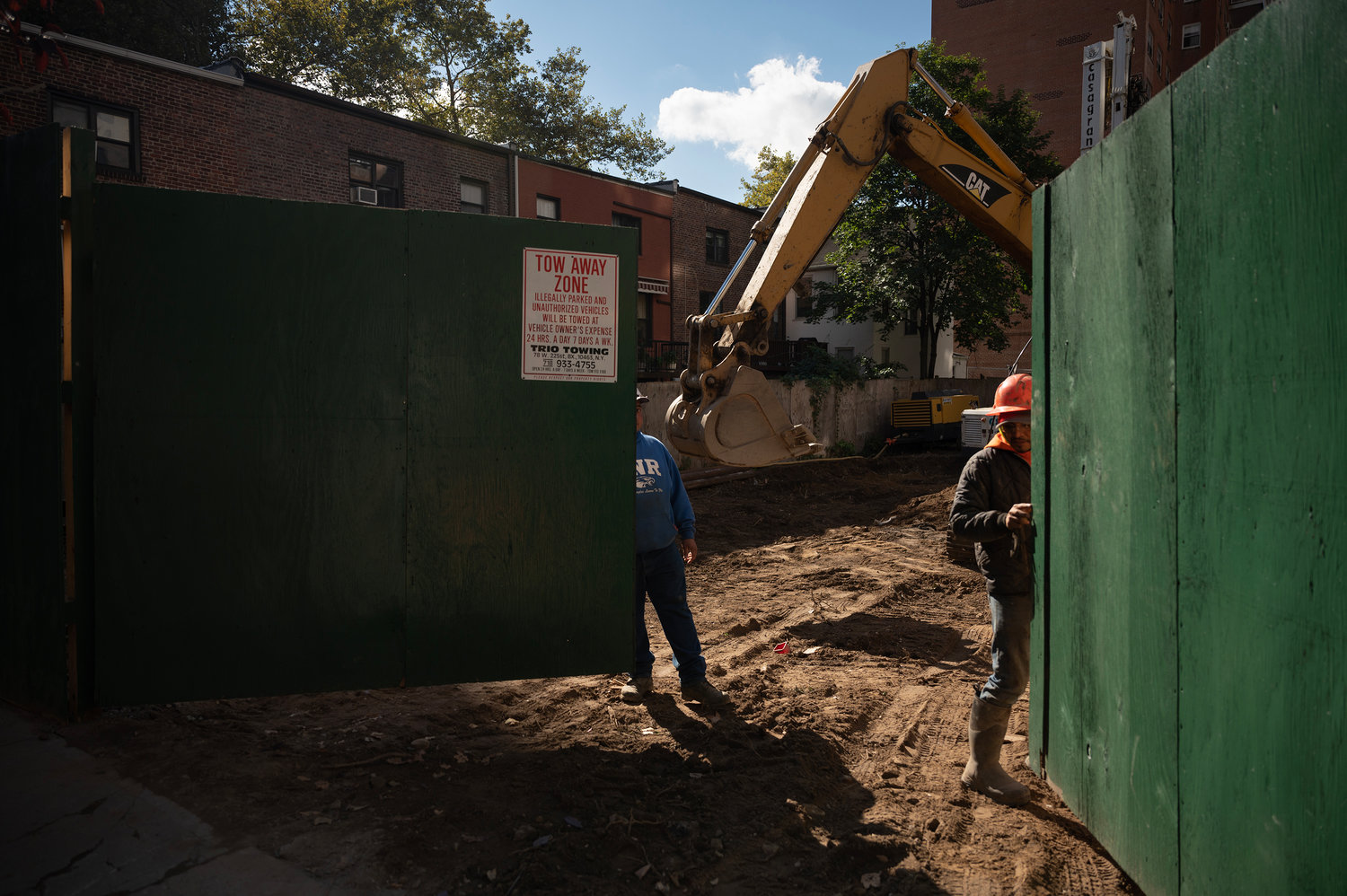 Workers at the site of the proposed International Leadership Charter middle school close the gate as they begin work.