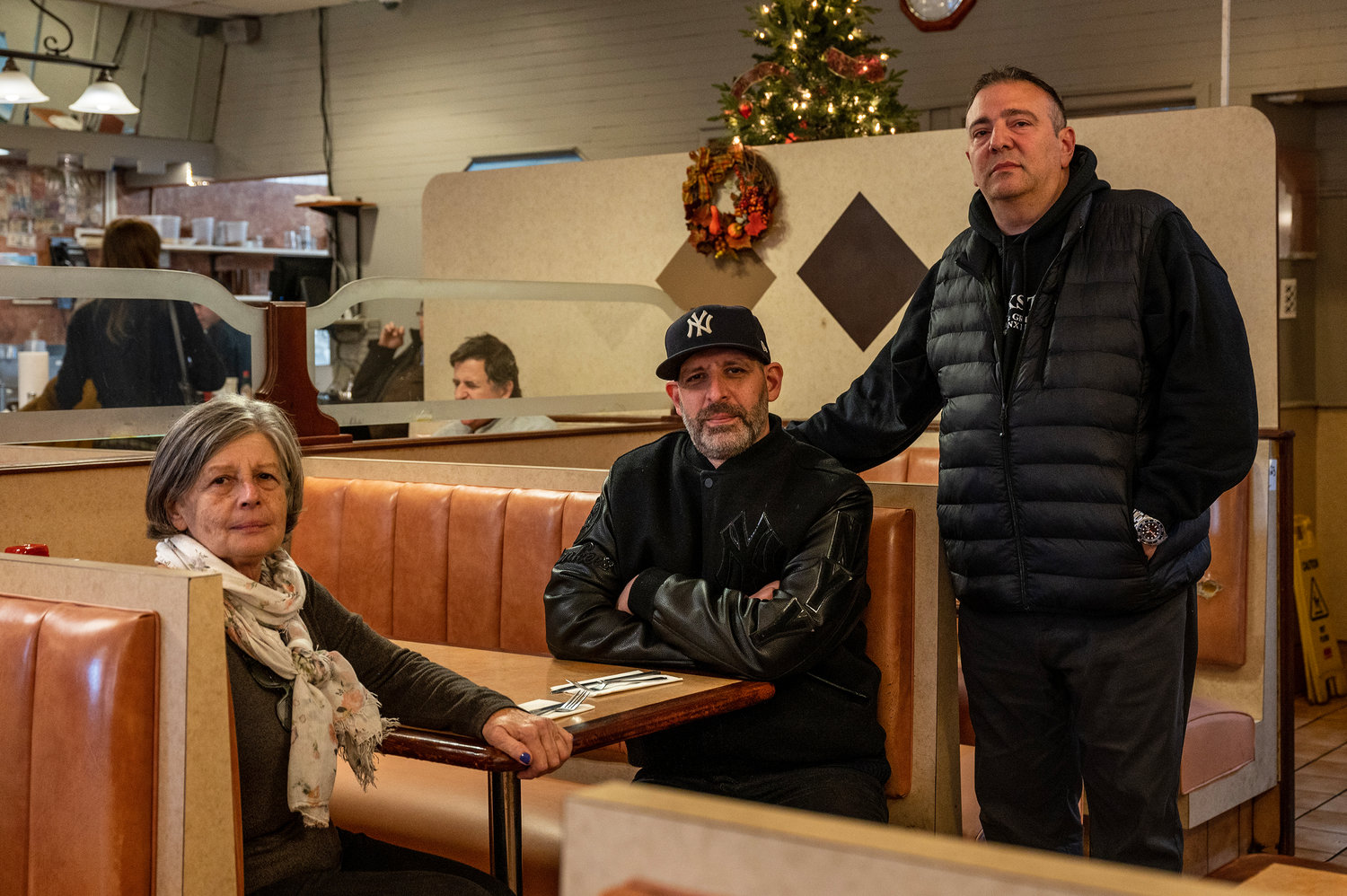 Owners Elizabeth Katechis, left, her son, Spiro Katechis, center, and nephew, Steve Catechis, right gathered at Blue Bay Restaurant on their last day in business after 48 years Nov. 28.