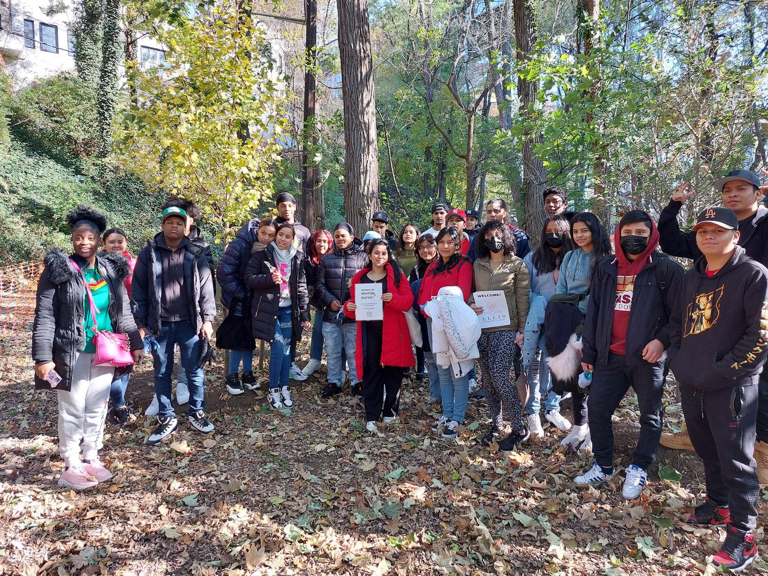 Nearly 40 students and three teachers from Elllis Preparatory Academy on the campus of John F. Kennedy High School gave back to nature and the community Nov. 23. The Friends of Spuyten Duyvil in partnership with the New York City parks department cleared out weeds and trails at Spuyten Duyvil Shorefront Park. Students,  shown at left and above, also cared for native trees. Below, some of the wood students cleared from the trails were placed near the Spuyten Duyvil Metro-North station.  “It has been a true pleasure nurturing community engagement and providing service learning opportunities to the Ellis Preparatory Academy community for the past 14 years every Thanksgiving season,” said Annel Lopez, internship program director and parent coordinator at the school.