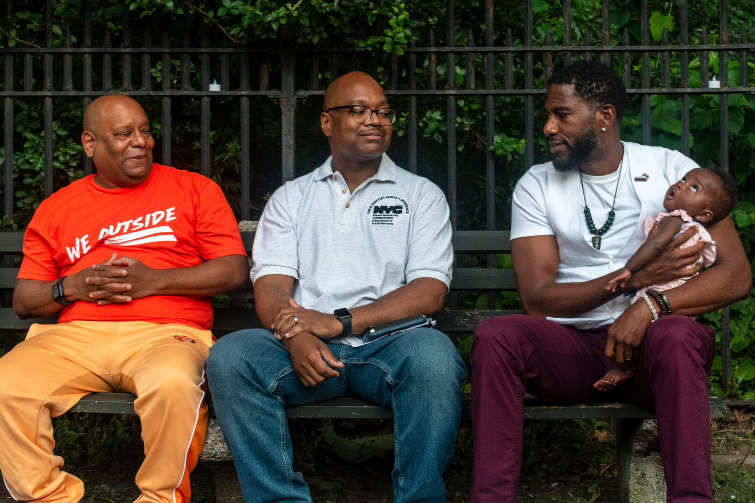 Social services commissioner Gary Jenkins, center, who oversees the city’s vast shelter system, shares a park bench with public advocate Jumaane Williams and his newborn baby, right, and 'homeless hero’ Shams DaBaron, left, New York City’s unofficial spokesperson for the ‘unhoused’ July 30.