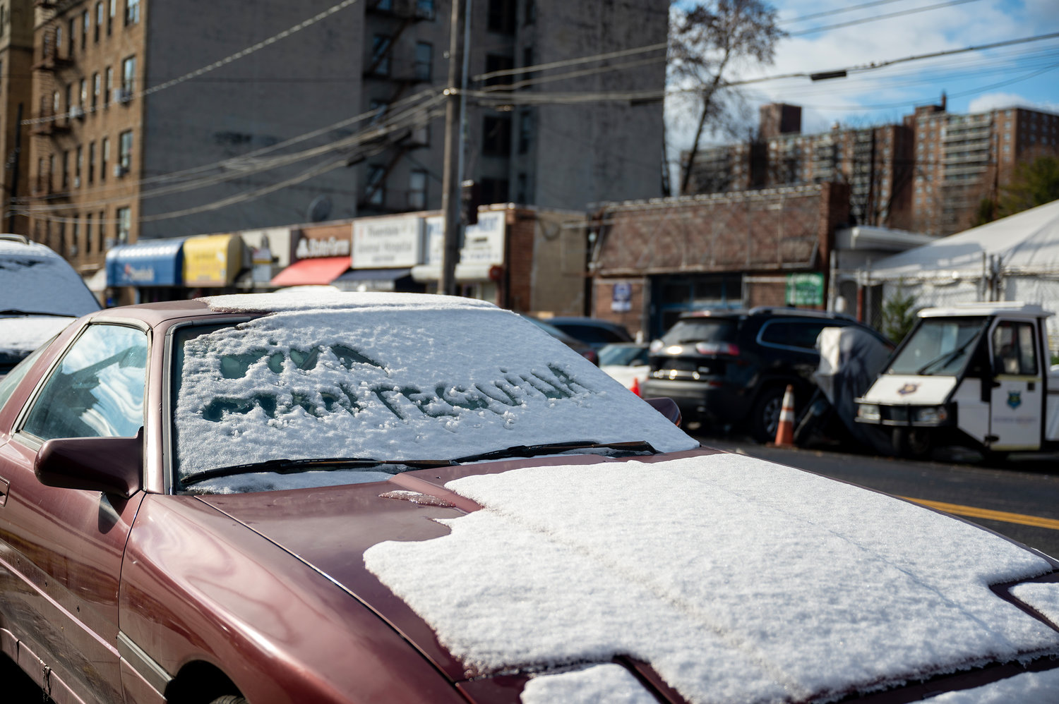 The words "Viva Mantequilla" written in snow on a car parked in Kingsbridge on Dec. 12, 2022.
