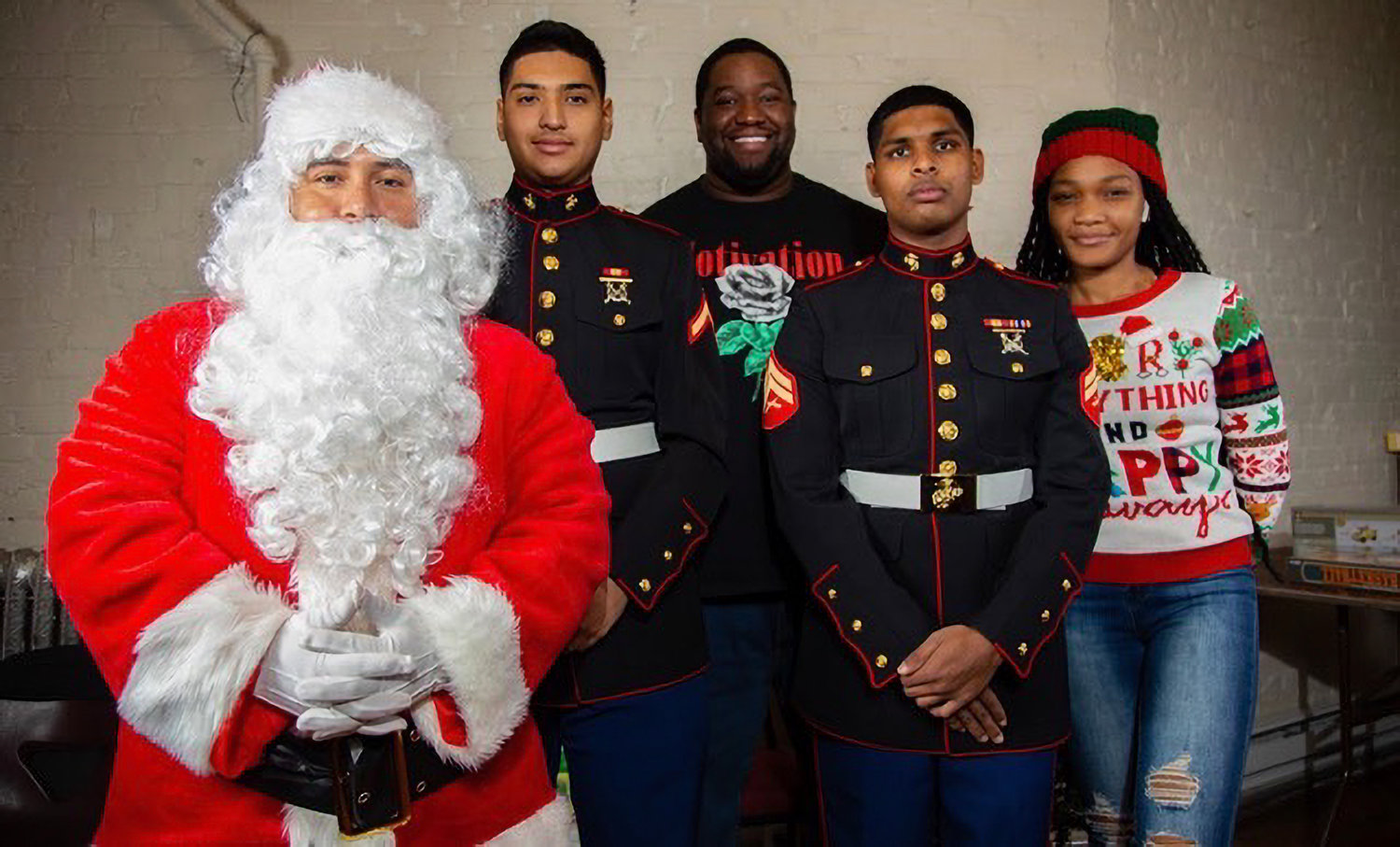 Gonzalo Duran, aka Santa Claus, strikes a pose with some Marines and their family members during a previous event as part of his company Devil Dog USA’s Santa program where military families are given presents donated by community groups.