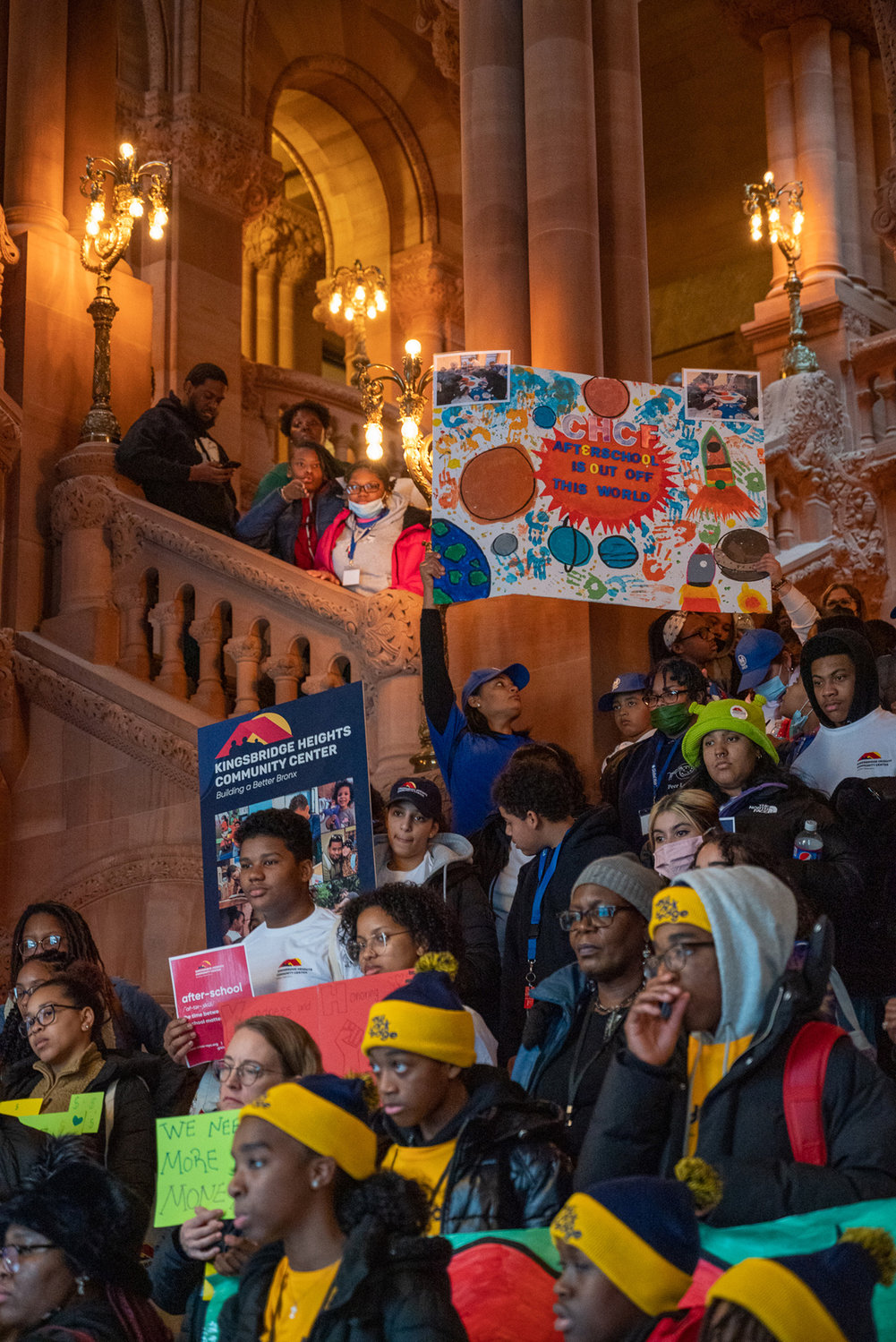 Teens from Kingsbridge Heights Community Center stand on the great staircase at the Capitol in Albany with signs asking for more afterschool funds. They visited their legislators on Jan. 25.