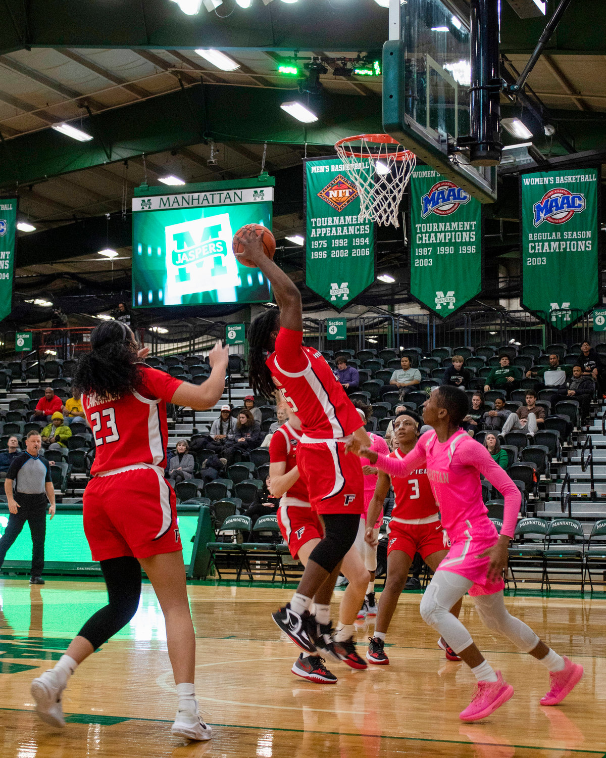 The Jaspers were out of their customary green and white uniforms and donned pink in honor of National Girls & Women in Sports Day, which was Feb. 1. On Feb. 2, Jasper guard Dee Dee Davis watches as a Fairfield player tries to convert a rebound as Manhattan College defeated Fairfield University, 53-46, at Draddy Gymnasium. Bronx borough president was in the house to help the school celebrate the 50th anniversary of Title IX.