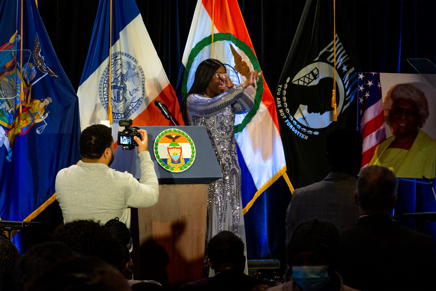 Borough president Vanessa Gibson signals a little Bronx pride during her address at Manhattan College’s Kelly Commons March 1. A portrait of the late Aurelia Greene – New York District 77 assemblywoman and Gibson’s political mentor – is propped behind her.
