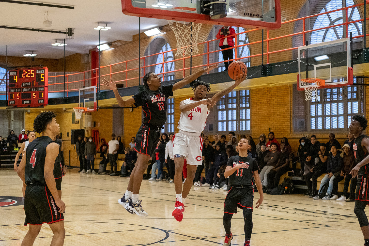 Very early in the first quarter in the Governors’ playoff game against Far Rockaway, Jason Coachman makes his way to the basket for a layup. DeWitt Clinton High School trailed early but powered past the Sea Horses, 66-40 to advance in the citywide playoffs.