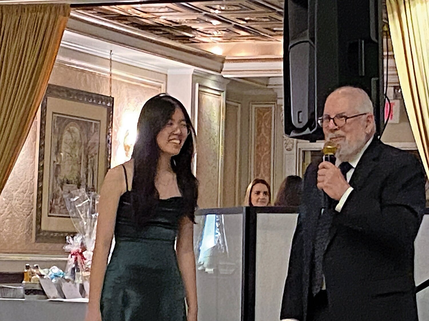 Richard Stein, former publisher of The Riverdale Press and son of co-founder Celia Stein, awards Shiya Lin, a Bronx High School of Science senior, with the first Celia Stein Kiwanis scholarship Friday night.