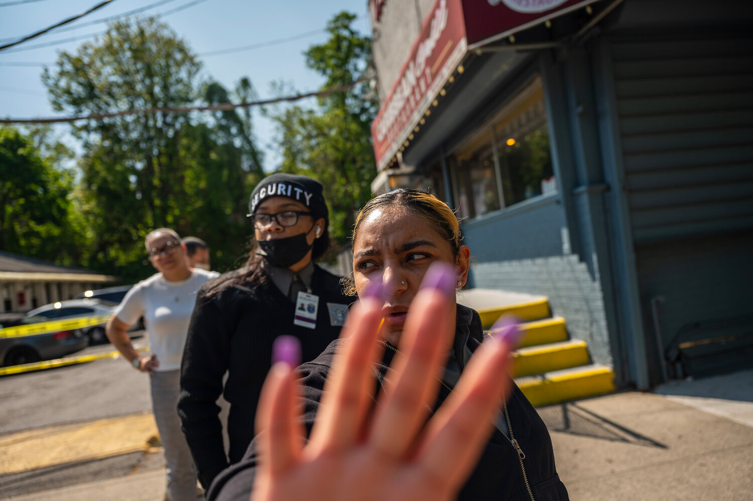 An  A&H Security guard reaches for the camera in an uncomfortable scuffle with a photographer standing on the right-of-way in front of the Van Cortlandt Motel on Wednesday, May 10.