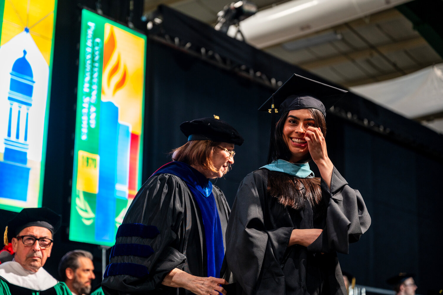 A graduate at Manhattan College’s commencement is jubilant as she reaches the stage to receive her diploma Wednesday.