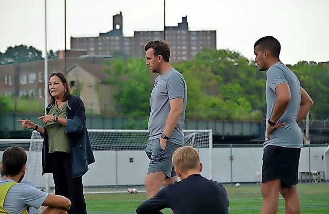 Irma Garcia recently spoke to the Manhattan men’s soccer program coached by Jorden Scott, center. Garcia officially stepped into her role as athletics director on Aug. 1 following the resignation of Marianne Reilly.