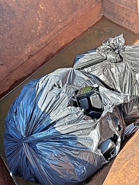 Plastic garbage bags in the Dumpster at the Van Cortlandt Motel contained unopened meal kits provided by New York City for asylum seekers there. Many of the migrants could not eat the food, which management threw out.