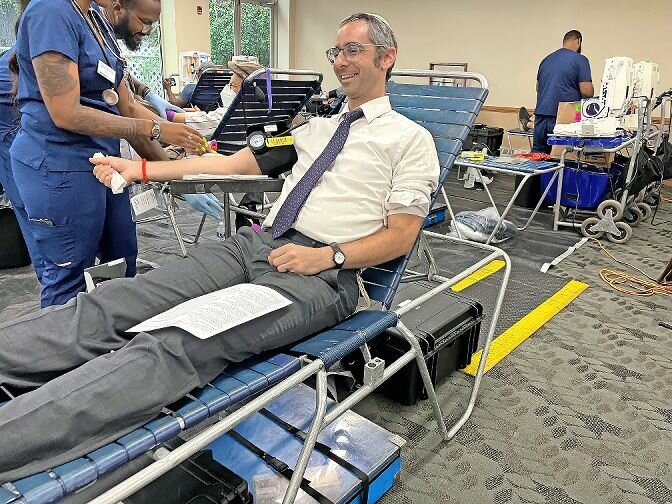 Rabbi Steven Exler gives blood at the annual blood drive at the Hebrew Institute of Riverdale last Sunday. ‘Our mission as a synagogue is to kind of help the world in every way we can. Giving is what saves lives,’ Exler said.