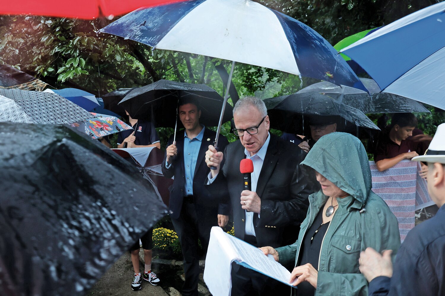 Some of the more than 30 people who showed up at Endor Community Garden to pay their respects to the victims of the Sept. 11, 2001 terrorist attacks braved the torrential rain. Among them were Assemblyman Jeffrey Dinowitz and Laura and Rob Spalter as well as Rev. Brian McCarthy of St. Margaret of Cortona.