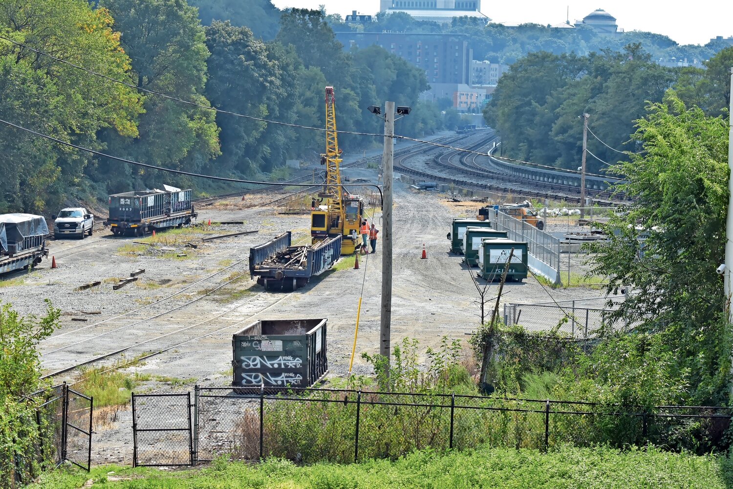 A cleared section of property along the Putnam greenway extension shows Metro-North employees working on a transfer station.