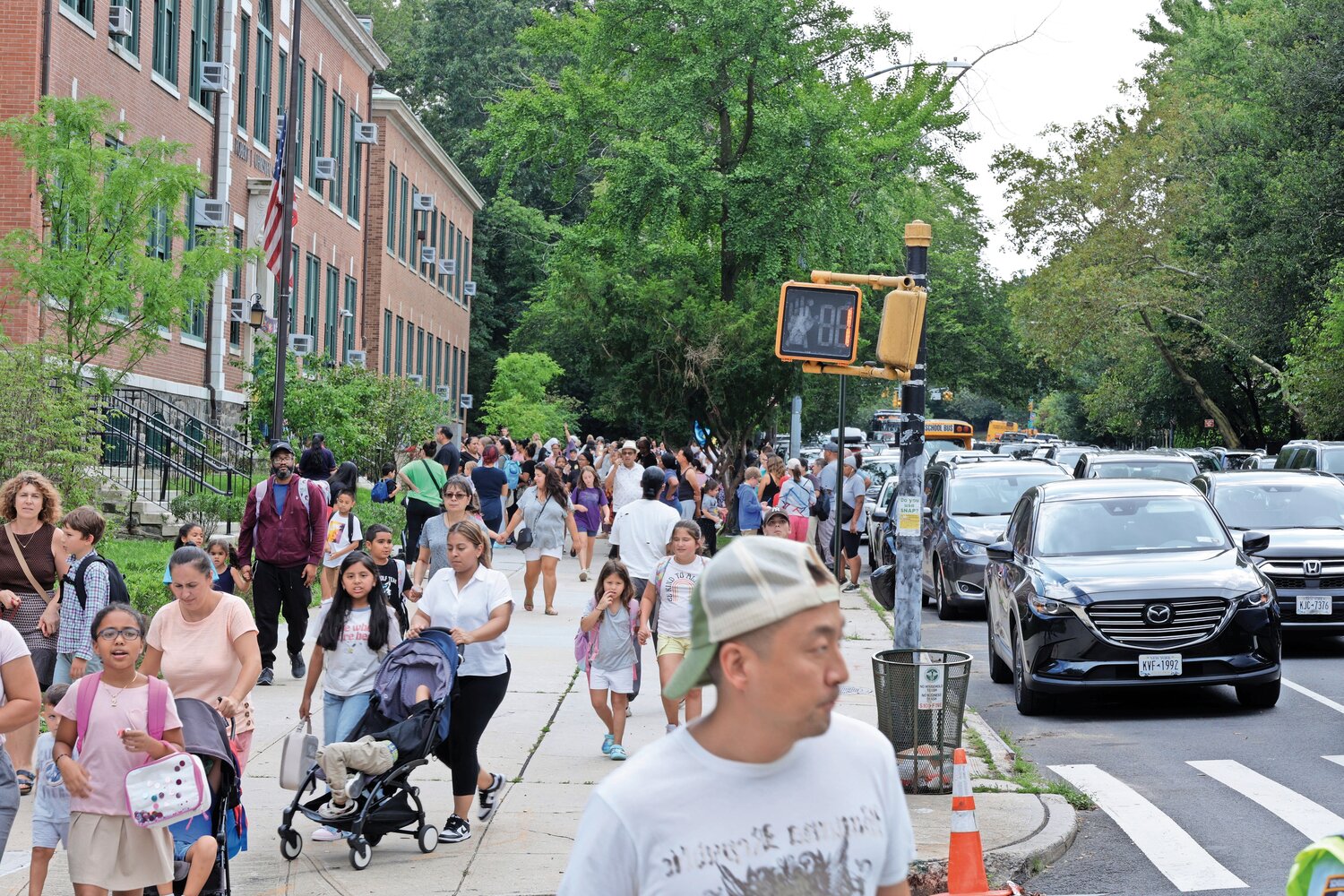 Amid a heat wave, hundreds of parents wait patiently to pick up their children at P.S. 81 Robert J. Christen School’s first day last Thursday.