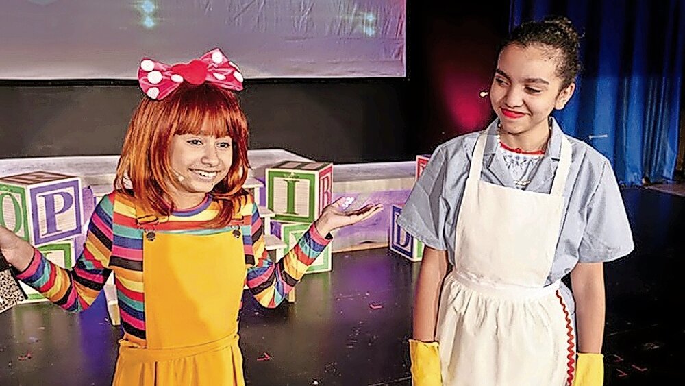Two young girls act during a ‘Junie B. Jones’ play put on by the Riverdale Children’s Theatre.  The theatre has put on many shows, including ‘The Wizard of Oz!’
