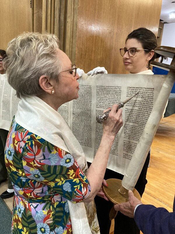 A member of the Riverdale Temple reads the Torah as part of the annual Simchat Torah celebration held during the first weekend of October. It was during the celebration held by Jews around the world that Hamas attacked Israel.