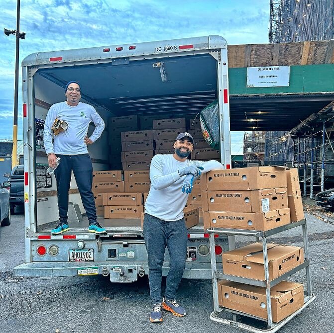 Members of Oyate Group distribute some of the more than 2,000 frozen turkeys to people prior to Thanksgiving Day. Oyate COO Jason Autar and chief executive Tomas Romas took part.