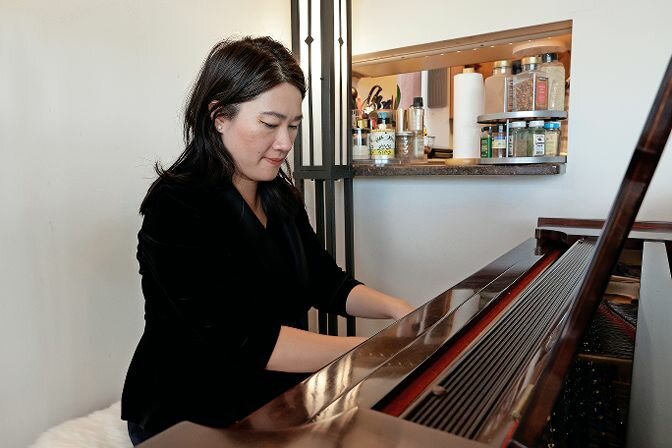 Mun-Tzung Wong, shown in her home, plays her piano. That is one of the many musical skills she has mastered.