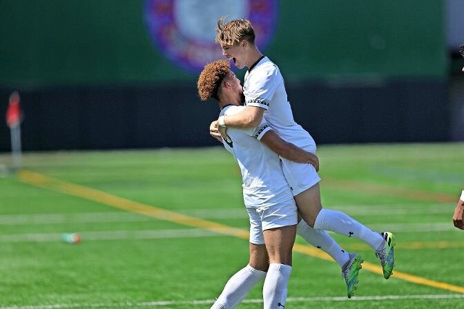 Gunnar Studenhofft lifts up a teammate during a game last season for the Manhattan College men's soccer team.