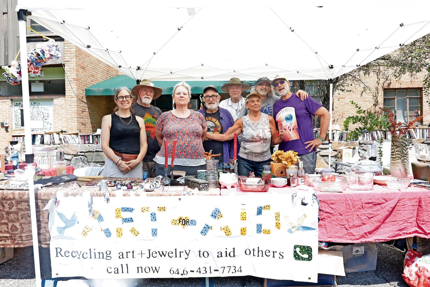 The members of Art for AID work the Sunday Market. The group dedicates its efforts to taking in odds and ends and using the proceeds to raise money for local causes. Richard Feldman is an active participant.