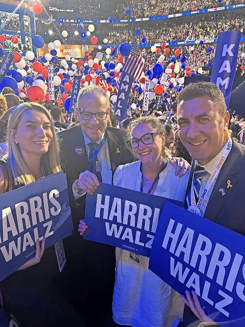 Democratic National Convention delegates Virginia Krompinger, left, and Assemblyman Jeffrey Dinowitz, second left, Democratic activist Kara Pitek and Councilman Eric Dinowitz celebrate after Vice President Kamala Harris accepted the party’s nomination for president.