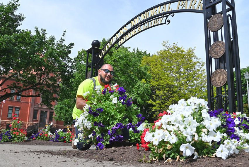 GETTING READY &mdash; John Lavalla, of the Rome Department of Public Works, prepares to plant flowers at Veterans Memorial Park on Thursday as city workers and volunteers were busily preparing for Memorial Day activities. See story,  page 2.
