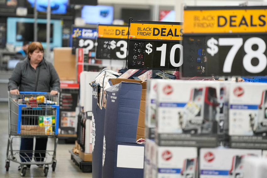 Signs advertise Black Friday deals at a Walmart in Secaucus, N.J., Tuesday, Nov. 22.