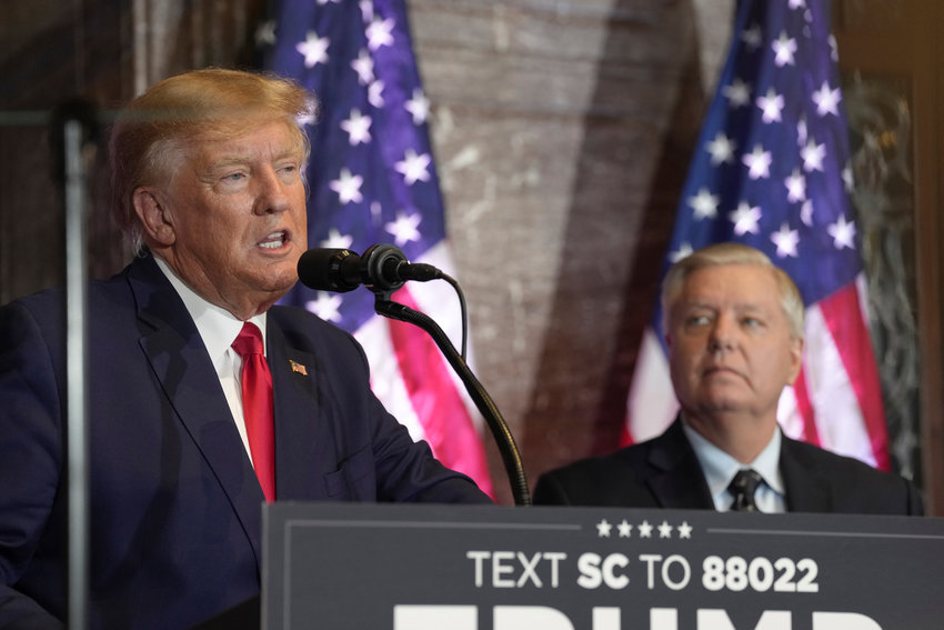 Former President Donald Trump, left, speaks at a campaign event as Sen. Lindsey Graham, R-S.C., looks on at the South Carolina Statehouse, Saturday, Jan. 28, in Columbia, S.C.