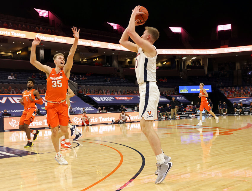 THREE-POINTER &mdash; Virginia forward Sam Hauser, right, shoots next as Syracuse guard Buddy Boeheim during a college basketball game on Monday night in Charlottesville, Va.  Hauser hit seven of Virginia&rsquo;s 14 3-pointers as the Cavaliers won 81-58.