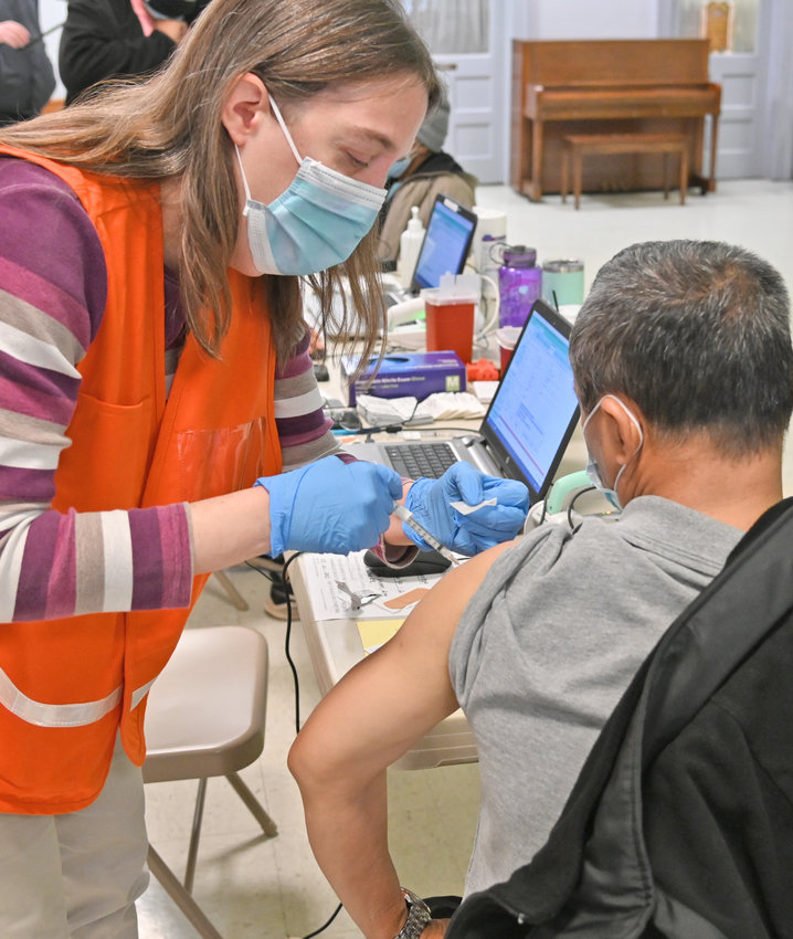 A SHOT IN THE ARM &mdash; Vaccinator Patrica Doyle, a registered nurse from Senior Network Health MVHS administers a dose of the Pfizer COVID-19 vaccine to a patient at the pop-up clinic at the Tabernacle Baptist Church in Utica on Monday.