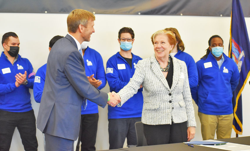 EYES ON APPRENTICESHIPS &mdash; Indium Corporation President and Chief Operating Officer Ross Berntson, left, shakes hands with New York State Department of Labor Commissioner Roberta Reardon, during a ceremony on Wednesday to formally sign and register the company&rsquo;s apprenticeship  program.