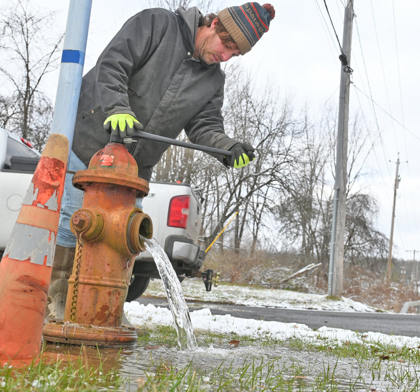FIXING THE FLOW &mdash;&nbsp;Billy Knudsen of the Town of Lee Water Department turns on a hydrant along Turin Road after a six-inch pipe was fixed just north of this hydrant Monday. Knudsen said a line of hydrants needed to be slowly turned on to bleed air from the water lines. Stokes Elementary School was closed today and residences in the town south of the Route 26, Stokes-Lee Center Road were without water because of the break. Bottled water was delivered to the school for Tuesday classes. Officials said Monday night that the earliest the boil water order would be lifted is Wednesday morning, following testing by the Mohawk Valley Water Authority. Residents can check the Town of Lee website for updated information regarding the boil water status.
