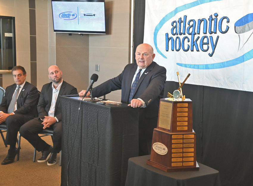 POSTSEASON HOCKEY &mdash;&nbsp;Atlantic Hockey Association Commissioner&nbsp;Robert DeGregorio announces Thursday that the league will hold its 2022 championship semifinals and finals at the Utica Aud in March. Joining him are Utica Mayor Robert Palmieri, left, and Utica Comets President Robert Esche. At right is the Jack Riley Trophy, which goes to the conference&rsquo;s postseason champion, along with a berth in the NCAA Division I men&rsquo;s ice hockey championship.