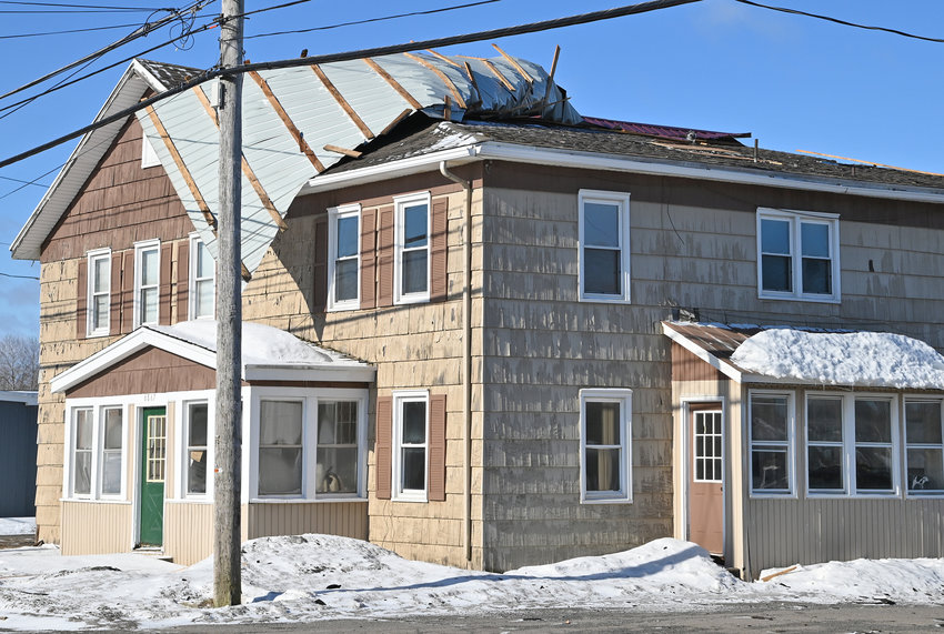 HIGH WINDS RIP ROOF &mdash; A sheet of metal roofing hangs off the top of 6866 S. James St. March 2, following March 1&rsquo;s heavy winds. Fire officials said no one was injured. They added that a second piece of metal roofing was blown into the roadway.