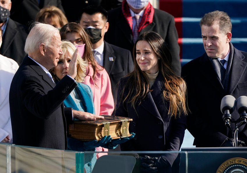 THE OATH &mdash; Joe Biden is sworn in as the 46th president of the United States by Chief Justice John Roberts as Jill Biden holds the Bible during the 59th Presidential Inauguration at the U.S. Capitol in Washington on Jan. 20.