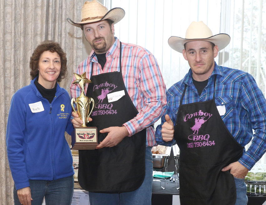 SPICING THINGS UP &mdash; The Joseph Michael Chubbuck Foundation has announced the return of its annual  CNY Wing Wars on  Saturday, Jan. 29 at Harts Hill Inn, 135 Clinton St., Whitesboro. Above, Barbara Chubbuck, of the foundation, presents a trophy to Jason Smith and Travis Fowler of Cowboy BBQ in this 2017 event file photo.