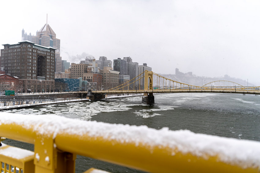 SNOW-COVERED DOWNTOWN PITTSBURGH &mdash; The icy Allegheny River and snow-covered Downtown Pittsburgh, Pa., skyline is seen from the Andy Warhol Bridge on Monday.