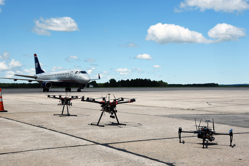 NEXT WAVE OF TESTING &mdash;&nbsp; This file photo shows Northeast Unmanned Aerial System Airspace Integration Research Alliance, Inc., drones alongside an airplane at the New York UAS Test Site at Griffiss International Airport in Rome. NUAIR has announced a partnership with Safetech Avionics to further develop the technology in the emerging field.