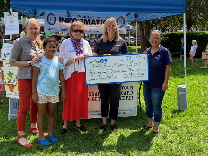 COMMUNITY SUPPORT &mdash;&nbsp;Representatives of Excellus BlueCross BlueShield present a Community Health Award to organizers of the Clinton Farmers Market in this file photo. The health insurance company has announced that a new round of the grant program has begun.