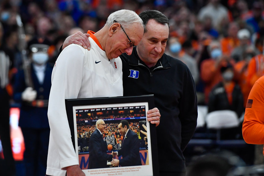 COACH K HONORED &mdash; Syracuse coach Jim Boeheim, left, presents Duke coach Mike Krzyzewski with a gift before a college basketball game in Syracuse on Saturday night. Krzyzewski was given a photo of him and Jim Boeheim that was mounted on a tile from the old Carrier Dome roof.