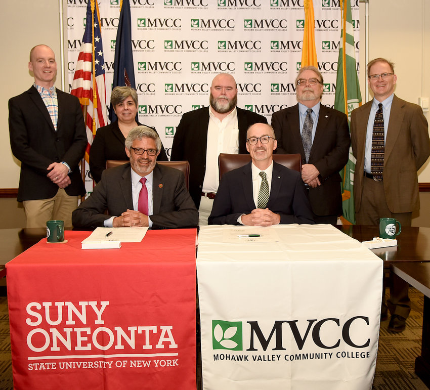 AGREEMENT &mdash; Officials from Mohawk Valley Community College and the State University of New York at Oneonta pose following the signing of an agreement between the two colleges to assist future teachers. From left, back row: Timothy Thomas, assistant vice president for Learning and Academic Affairs, MVCC; Sheila Flihan, dean of the School of Public and Human Services, MVCC; Lew Kahler, assistant vice president for Learning and Academic Affairs, MVCC; Richard Lee, provost, SUNY Oneonta; and Mark Davies, dean for the School of Education, Human Ecology, and Sports Studies. Seated: Alberto Cardelle, president, SUNY Oneonta; and Randall VanWagoner, president, MVCC.