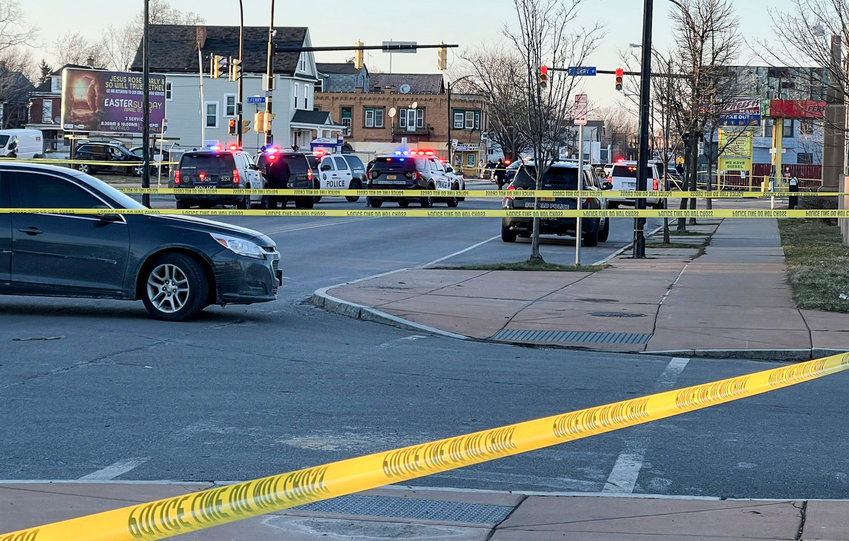 SCENE OF SHOOTING &mdash; Police vehicles and crime scene tape block an area where three police officers were hit by gunfire during a pursuit on Tuesday in Buffalo. The Buffalo Police Department says their injuries don&rsquo;t appear to be life-threatening.