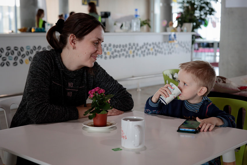 SAFE IN ROMANIA &mdash; Elena Litvinova, 33, an accountant from Mykolaiv, Ukraine, smiles at her 3-year-old son, Artem, after an interview with The Associated Press at a refugee center in Brasov, Romania, Wednesday.