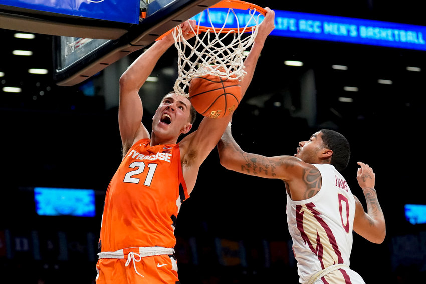 FORGOING FINAL YEAR OF ELIGIBILITY &mdash; Syracuse's Cole Swider (21) dunks against Florida State's RayQuan Evans (0) in the first half of an Atlantic Coast Conference men's basketball tournament game on March 9 in New York. Swider will forgo his final year of eligibility and declare for the NBA draft, he announced on social media.
