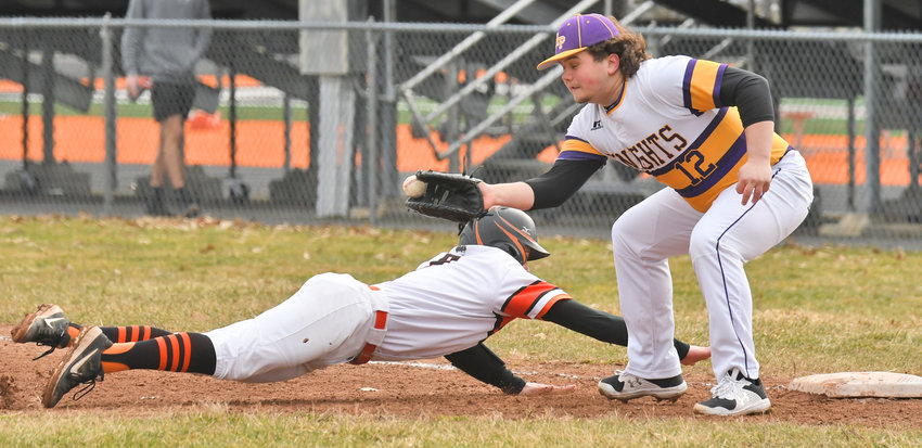 Rome Free Academy baserunner Tanner Brawdy dives back to first base safely with Holland Patent first baseman Alex McLaughlin reaching out for the catch and tag. RFA won 10-6 Monday at home.