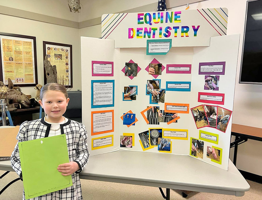 SINKING HER TEETH IN THE TOPIC &mdash;&nbsp;Raelinn Doxstader, of Remsen, displays her junior individual presentation &ldquo;Equine Dentistry&rdquo; at a recent 4-H event.