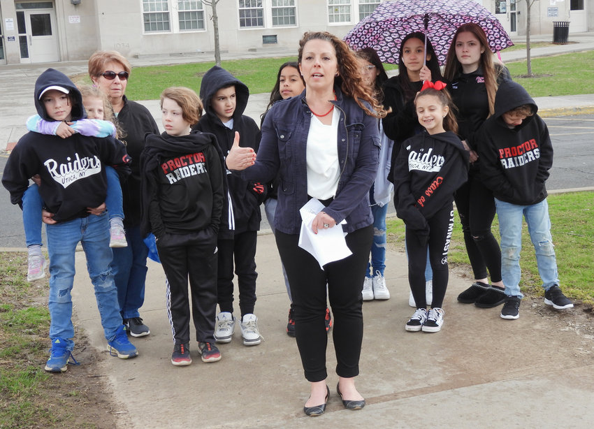 ACTION URGED &mdash; Utica School Board Candidate Tennille Knoop speaks outside Proctor High School on the need to address mental health in the District by pursuing funding for programs and initiatives