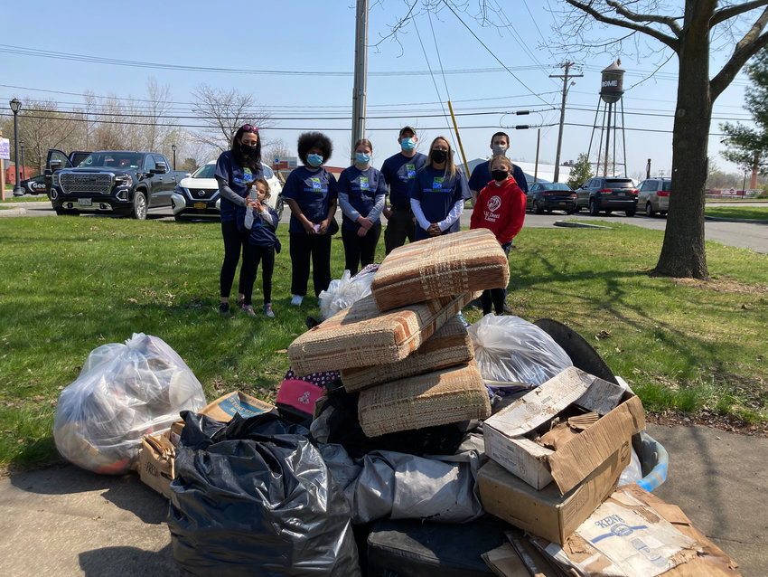 CANAL CLEAN SWEEP &mdash; Members of the Rome Free Academy Interact Club stand in front of a pile of rubbish collected during a past Earth Day cleanup around Bellamy Harbor Park in this file photo. Members of the group and the Rome Rotary Club will partner for a Canal Clean Sweeo from 1-4 p.m. Friday, April 24.