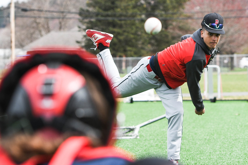 LOOKING IN &mdash;&nbsp;Proctor pitcher Manny Baez warms up his arm during practice on Monday at the high school in Utica. He&rsquo;s considered a key pitcher and outfielder for Proctor, according to coach Dave Guido.